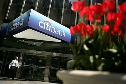 pedestrian passes the Citibank building in New York City.