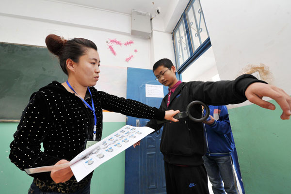 A student is inspected before taking the college entrance examination in Xiji county, Northwest China’s Ningxia Hui autonomous region, June 7, 2013. Big exam day kicks off