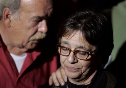 Mary Schindler, Terri Schiavo's mother, gestures as she talks to the media outside the Woodside Hospice where Schiavo is a patient on Tuesday, March 29, 2005 in Pinellas Park, Fla. Schindler asked Michael Schiavo to give her daughter back. At left is Bob Schindler, Terri's Schiavo's father. (AP Photo/Evan Vucci)