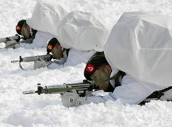 South Korean marines take aim during an annual severe winter season drill, to improve combat abilities in cold weather and heavy snowfall, in Pyongchang, about 180km (113 miles) east of Seoul February 8, 2006.