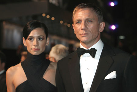 Actor Daniel Craig (R) arrives with a guest for the world premiere of the latest James Bond movie
