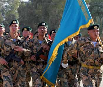 Kazakhstan soldiers march during a turn-over ceremony in the Iraqi city of Kut south of Baghdad December 19, 2005.